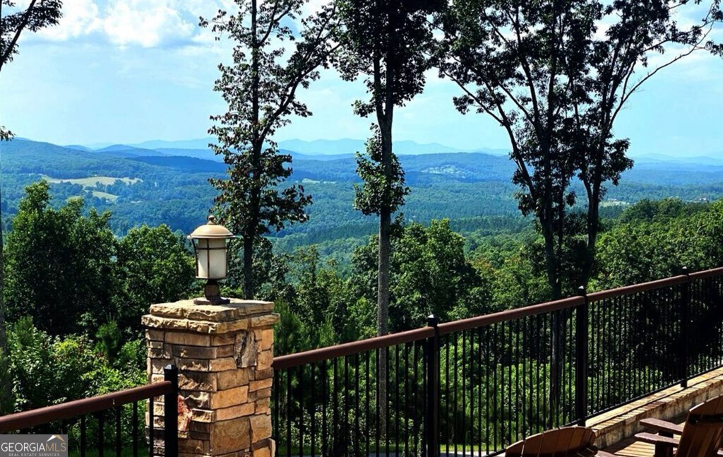 Lot 251 Ridge Pointe Way Blairsville, GA 30512 - Photo 14 of 18 a view of a balcony with chairs and wooden fence