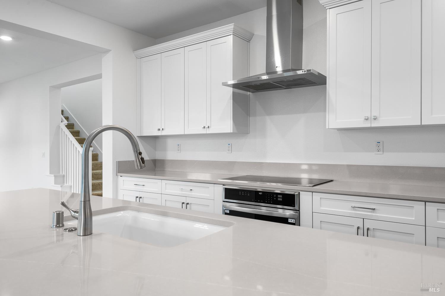 7337 Willowglen Drive Rohnert Park, CA 94928 - Photo 14 of 31 a kitchen with stainless steel appliances granite countertop white cabinets and a stove