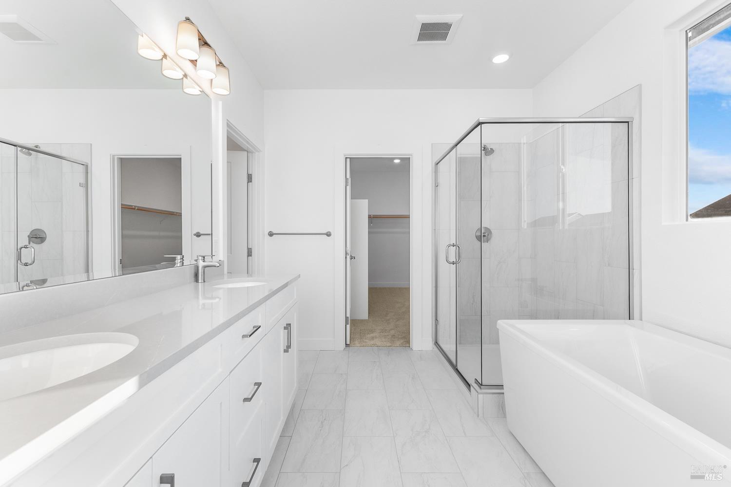 7337 Willowglen Drive Rohnert Park, CA 94928 - Photo 19 of 31 a bathroom with a double vanity sink a mirror a bathtub and shower