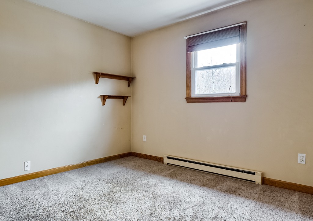 93 Center Depot Road, Unit 55 Charlton, MA 01507 - Photo 11 of 16 an empty room with windows