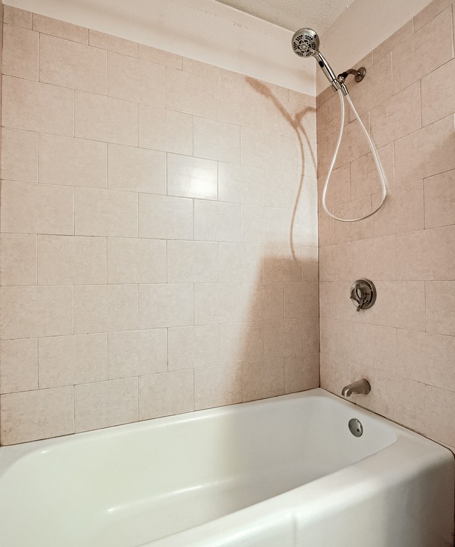 93 Center Depot Road, Unit 55 Charlton, MA 01507 - Photo 13 of 16 a bathroom with a bath tub with a shower