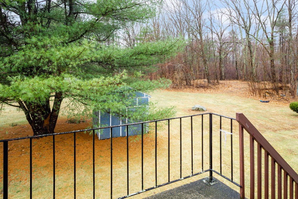 93 Center Depot Road, Unit 55 Charlton, MA 01507 - Photo 14 of 16 a view of staircase with railing and trees