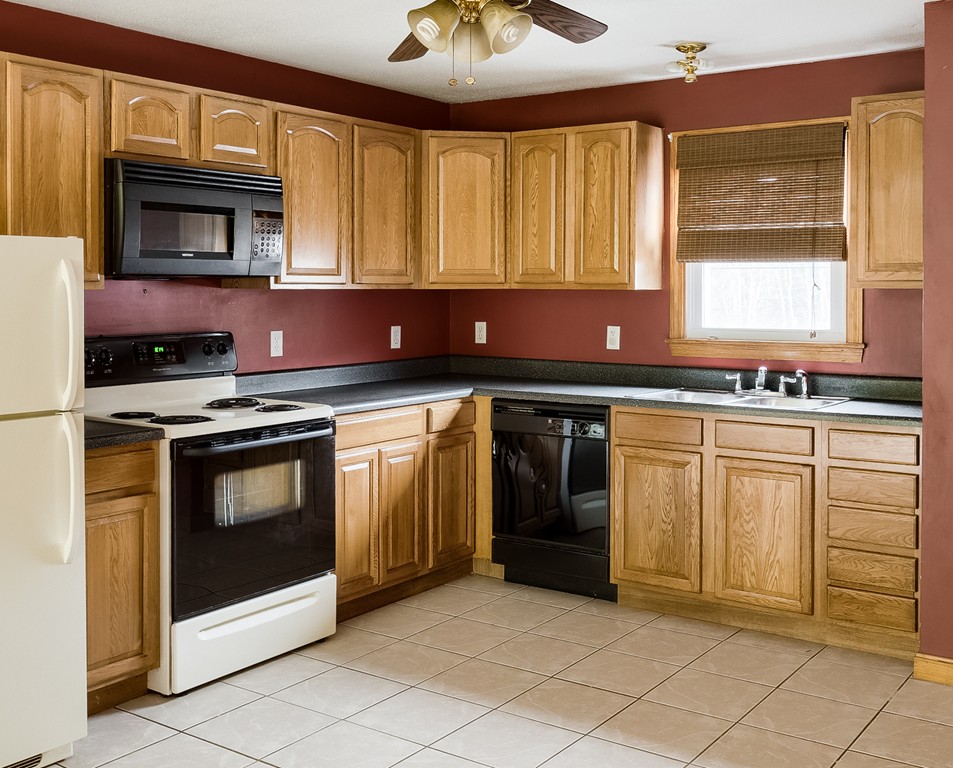 93 Center Depot Road, Unit 55 Charlton, MA 01507 - Photo 2 of 16 a kitchen with granite countertop a stove sink and cabinets