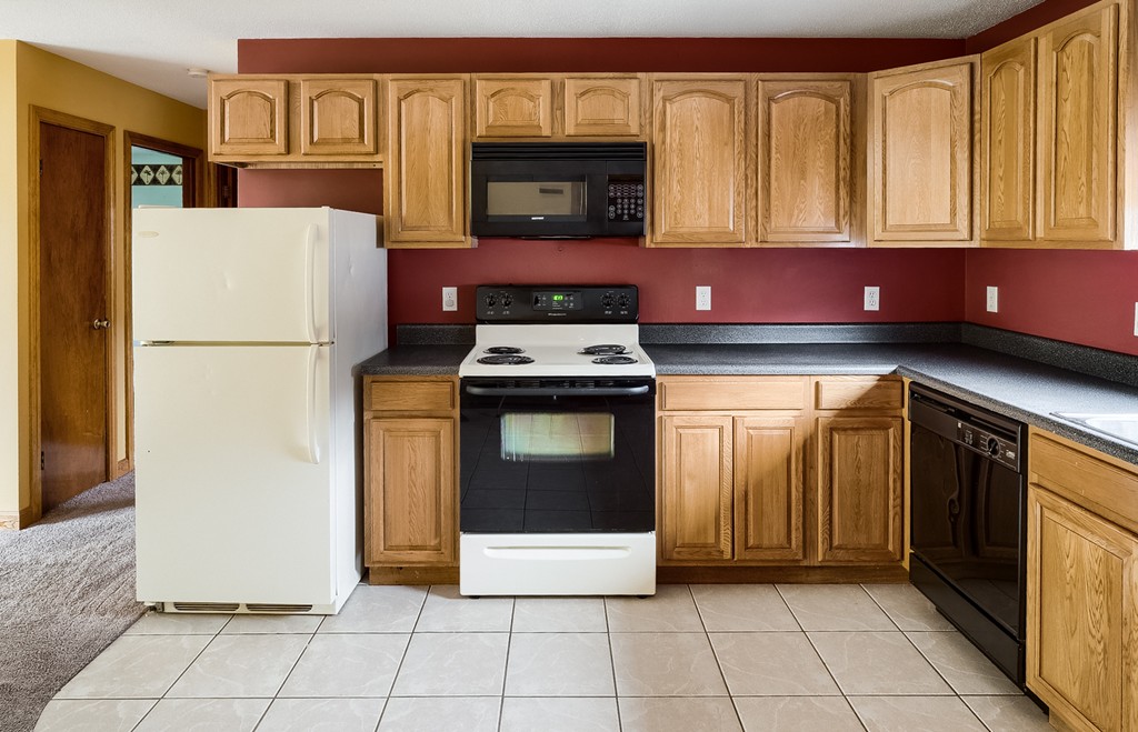 93 Center Depot Road, Unit 55 Charlton, MA 01507 - Photo 4 of 16 a kitchen with a stove top oven and cabinets