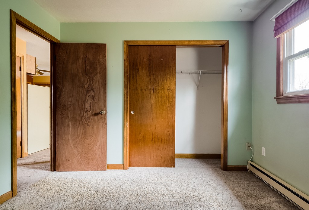 93 Center Depot Road, Unit 55 Charlton, MA 01507 - Photo 8 of 16 a view of an empty room with windows and closet