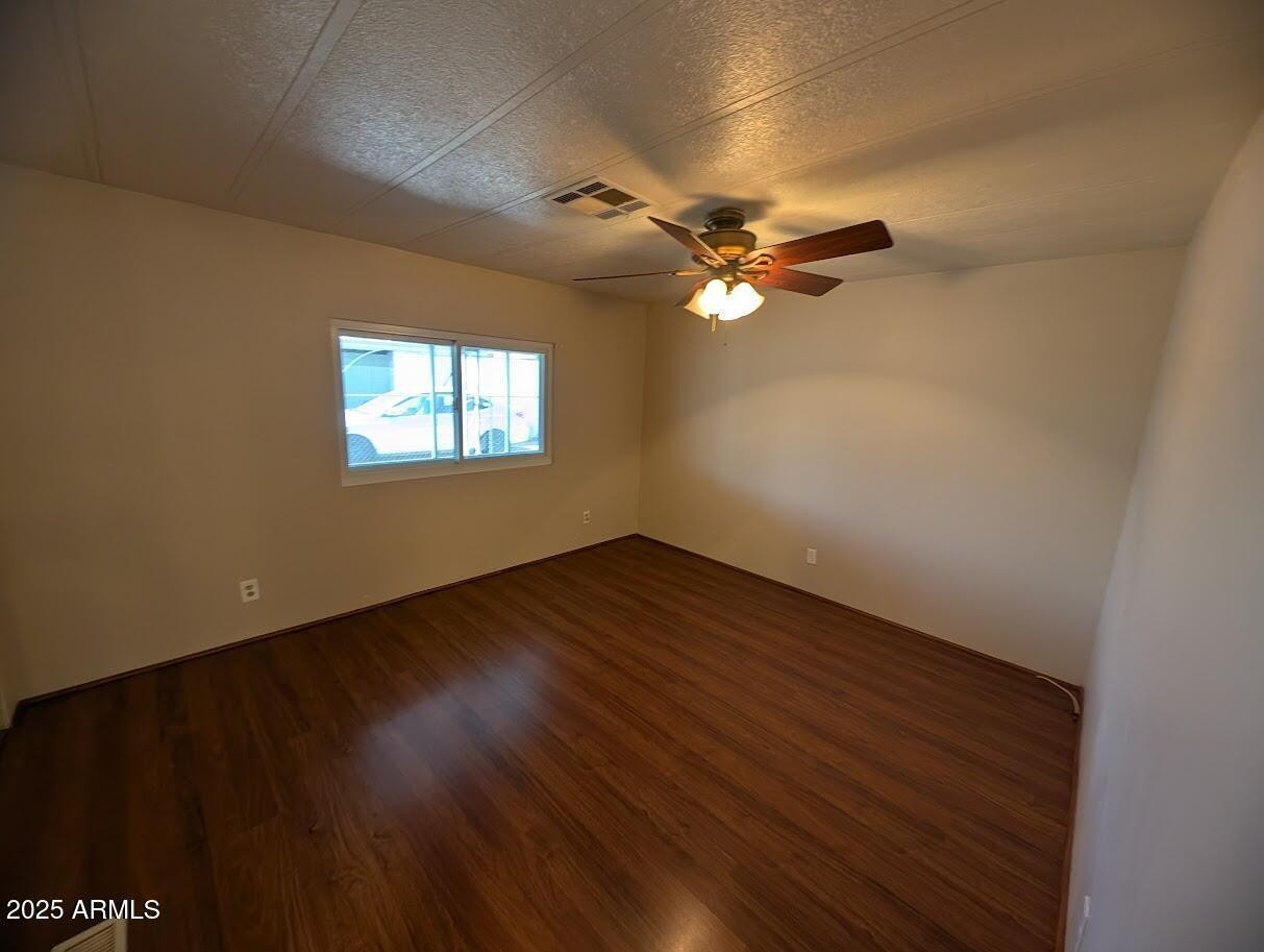 18003 North 2nd Street Phoenix, AZ 85022 - Photo 15 of 31 an empty room with wooden floor fan and windows