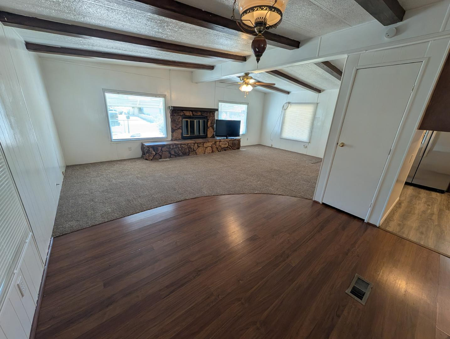 18003 North 2nd Street Phoenix, AZ 85022 - Photo 29 of 31 an empty room with wooden floor fireplace and windows