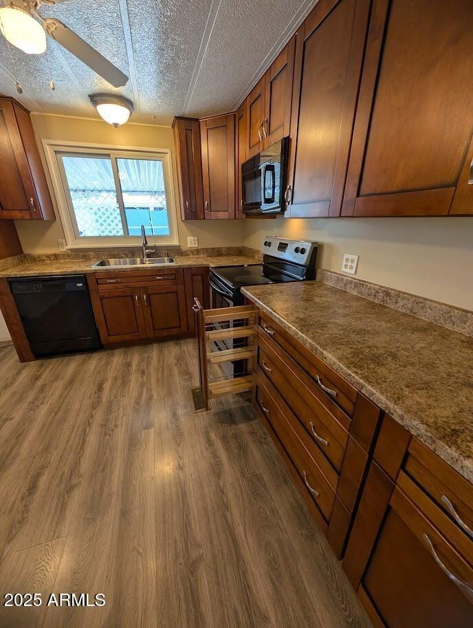 18003 North 2nd Street Phoenix, AZ 85022 - Photo 4 of 31 a kitchen with stainless steel appliances wooden cabinets a stove a sink and a microwave