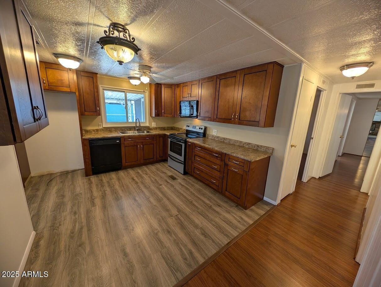 18003 North 2nd Street Phoenix, AZ 85022 - Photo 7 of 31 a large kitchen with wooden floors and stainless steel appliances