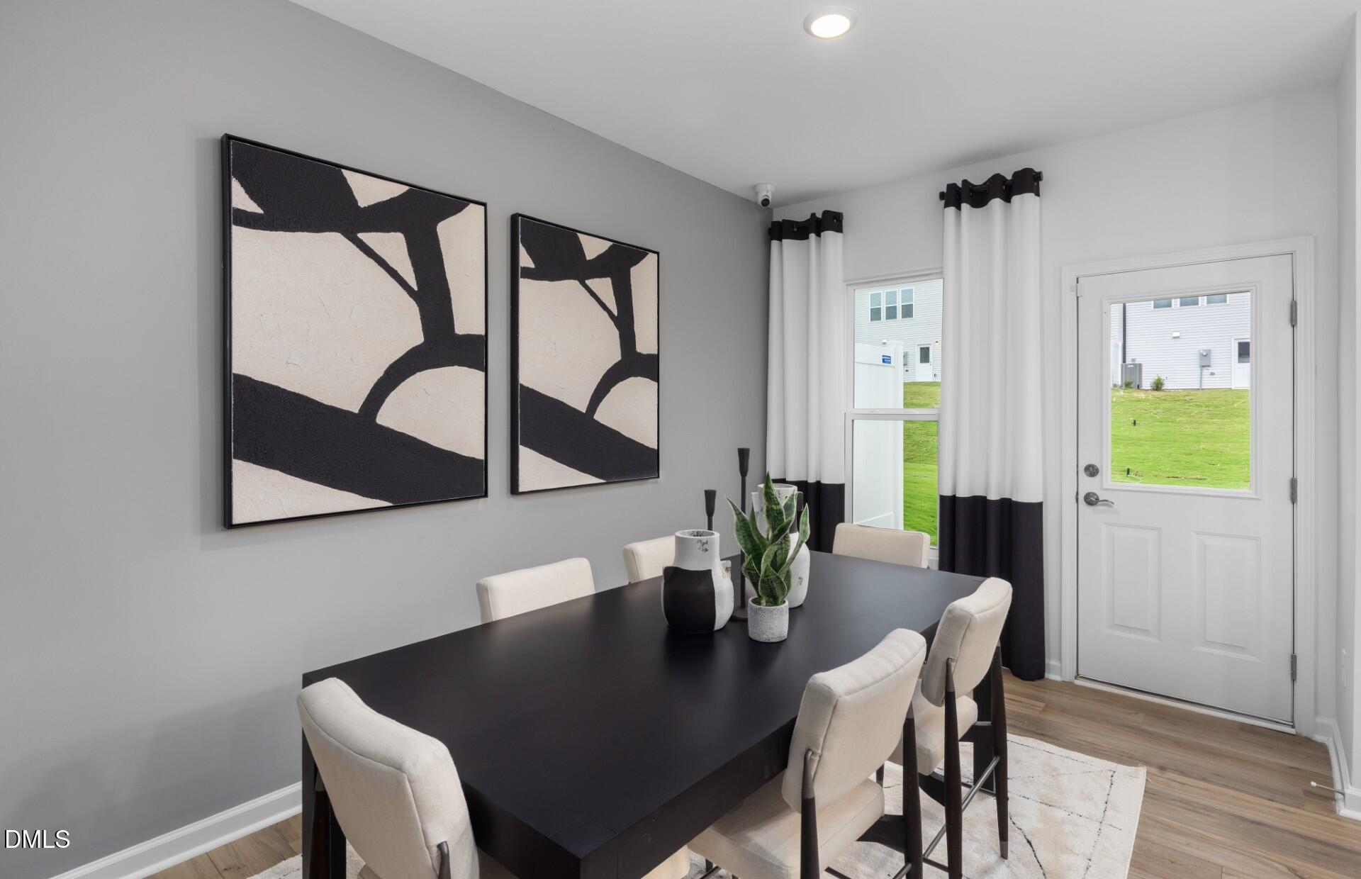 3032 Hammer Creek Road Durham, NC 27704 - Photo 8 of 19 a view of a dining room with furniture window and wooden floor