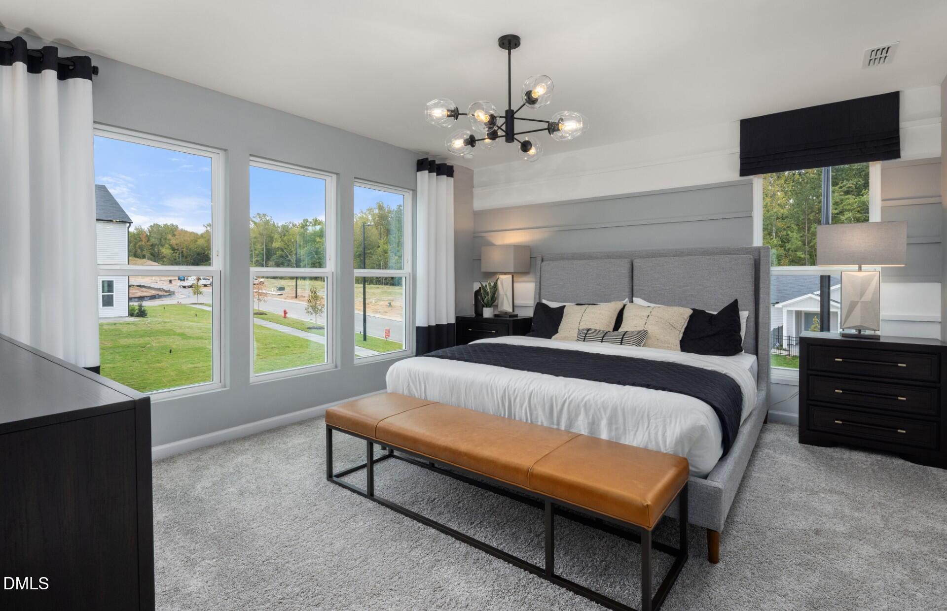 3032 Hammer Creek Road Durham, NC 27704 - Photo 9 of 19 a bed sitting in a bedroom next to a window