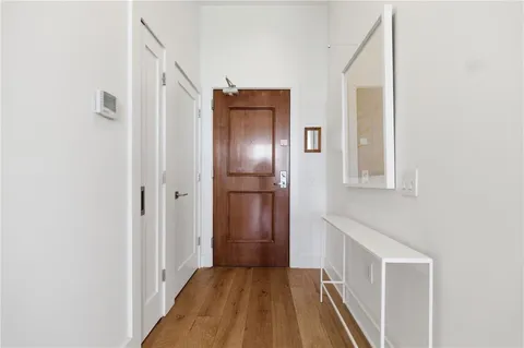 a view of a hallway with wooden floor