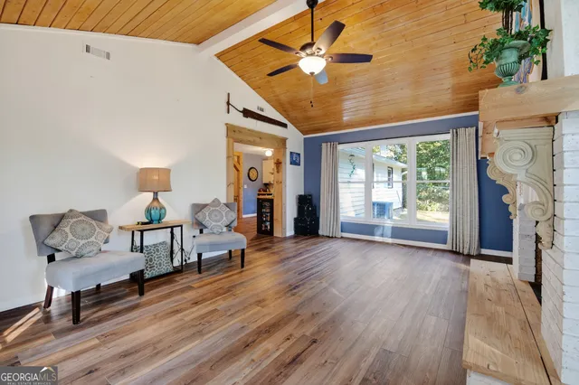 a living room with furniture a fireplace and a table