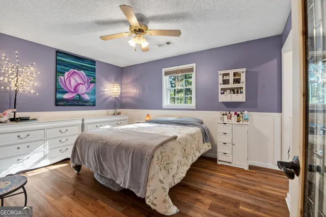 a spacious bedroom with a bed and a chandelier