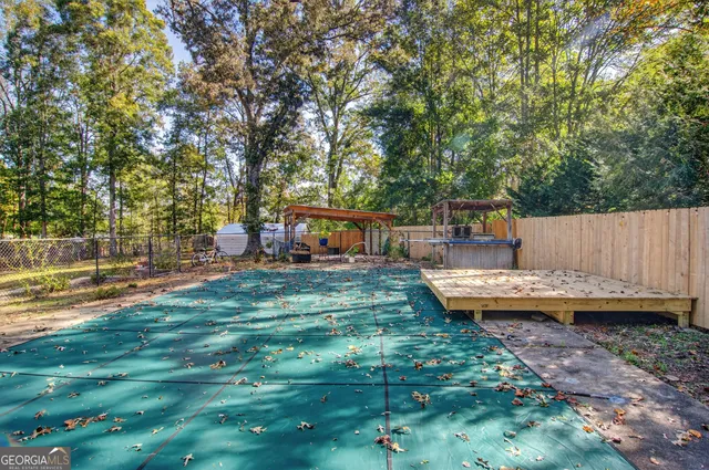a view of a house with backyard and sitting area