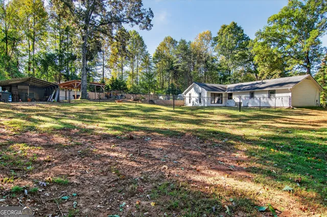 a view of a house with pool and sitting area