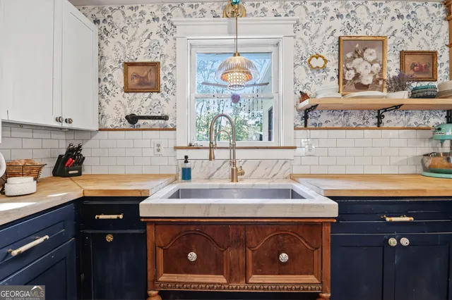 a kitchen with stainless steel appliances granite countertop a sink a stove and wooden cabinets