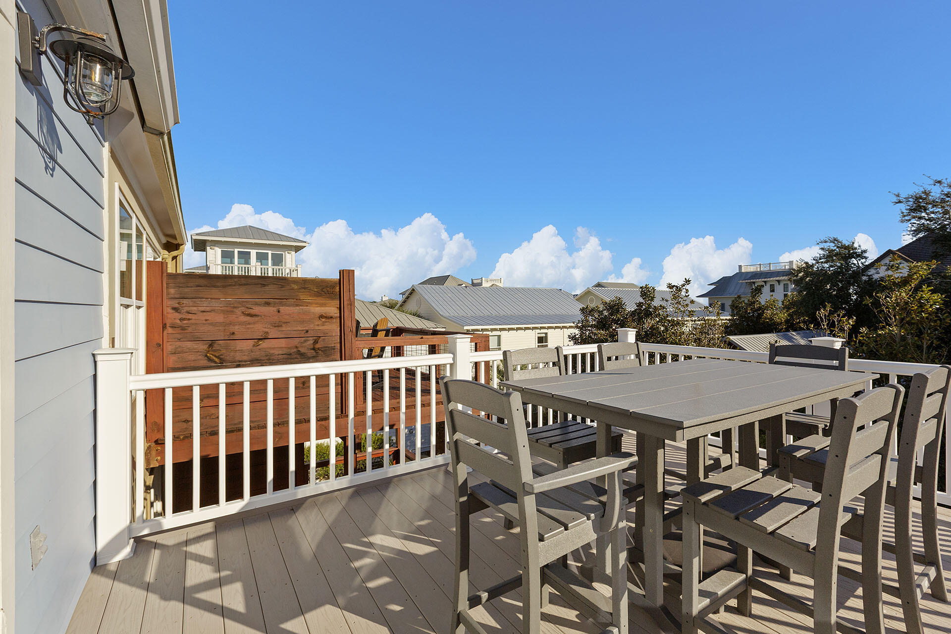 126 Hotz Avenue, Unit 5 Santa Rosa Beach, FL 32459 - Photo 12 of 13 a view of a patio with table and chairs with wooden floor