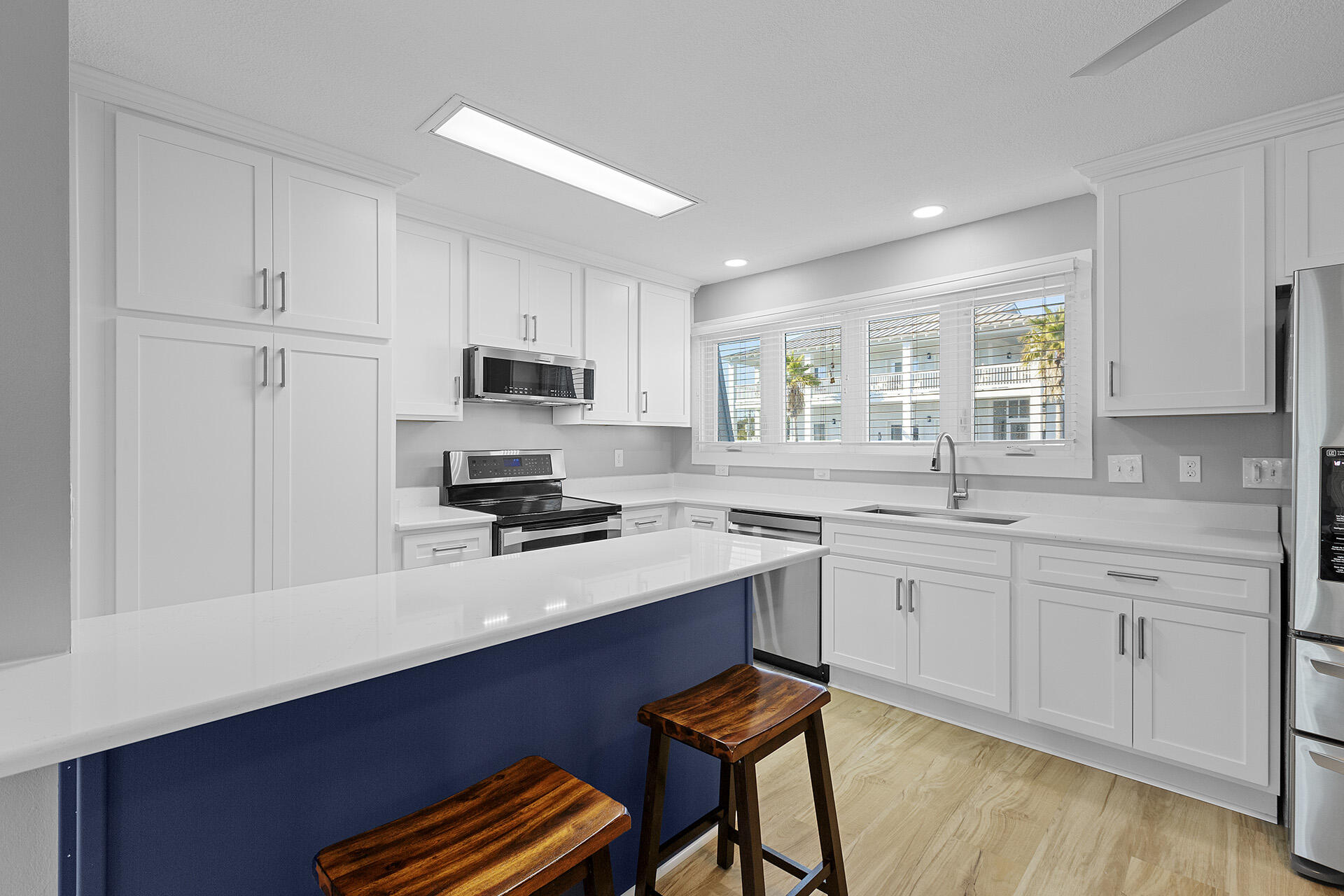 126 Hotz Avenue, Unit 5 Santa Rosa Beach, FL 32459 - Photo 2 of 13 a kitchen with stainless steel appliances a sink stove and cabinets
