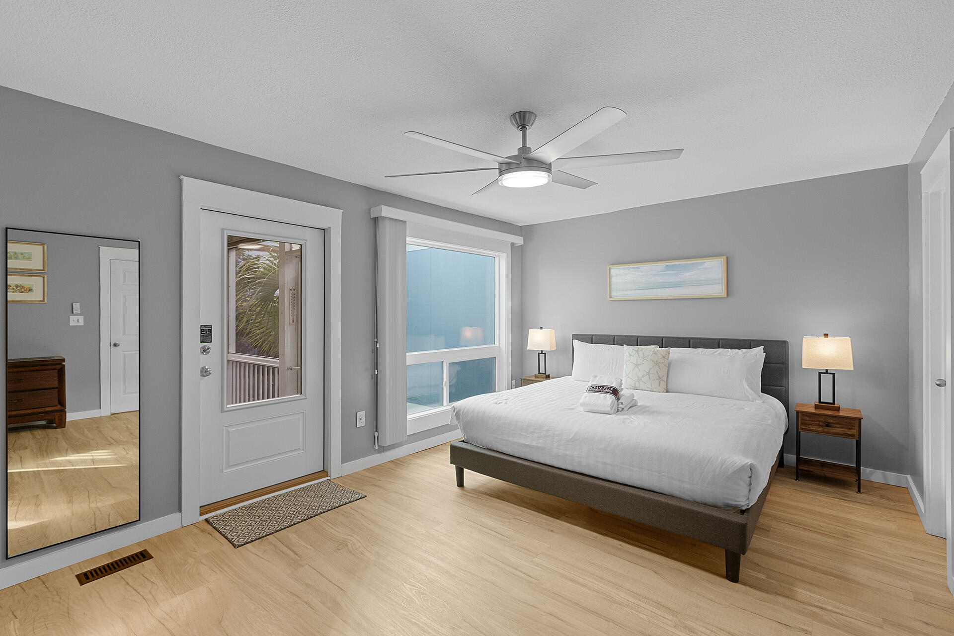 126 Hotz Avenue, Unit 5 Santa Rosa Beach, FL 32459 - Photo 7 of 13 a bedroom with a large bed and a chandelier