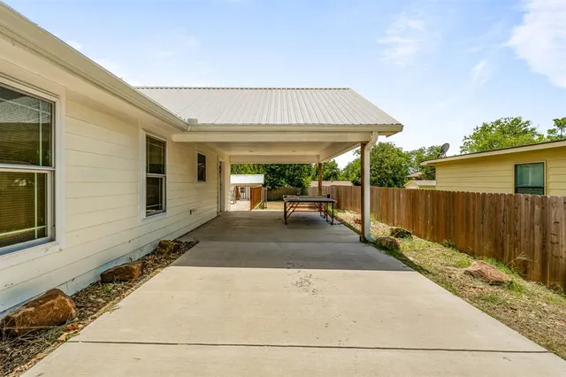 a patio with table and chairs