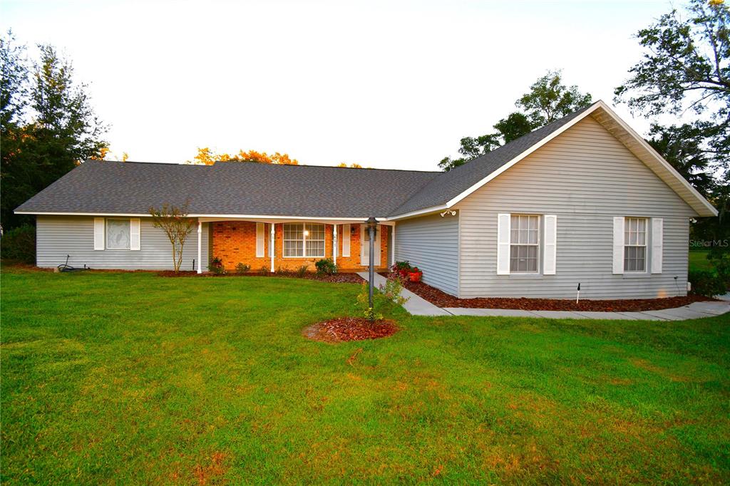 611 Old Eustis Road Mount Dora, FL 32757 - Photo 2 of 45 a front view of a house with a yard and garage