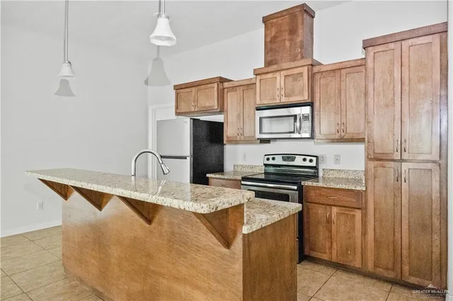 a kitchen with stainless steel appliances granite countertop a stove refrigerator sink and cabinets