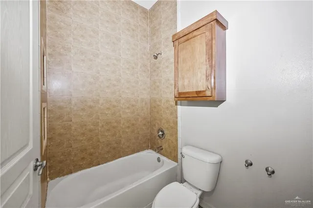 a bathroom with a toilet and a bathtub