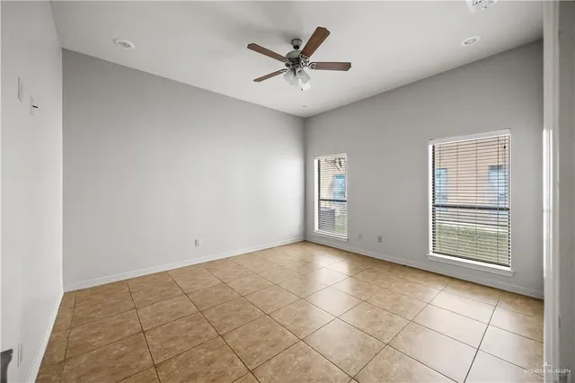a view of a livingroom with a ceiling fan and window