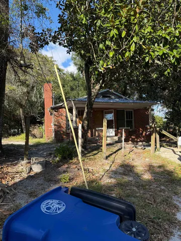 a view of a house with backyard porch and sitting area