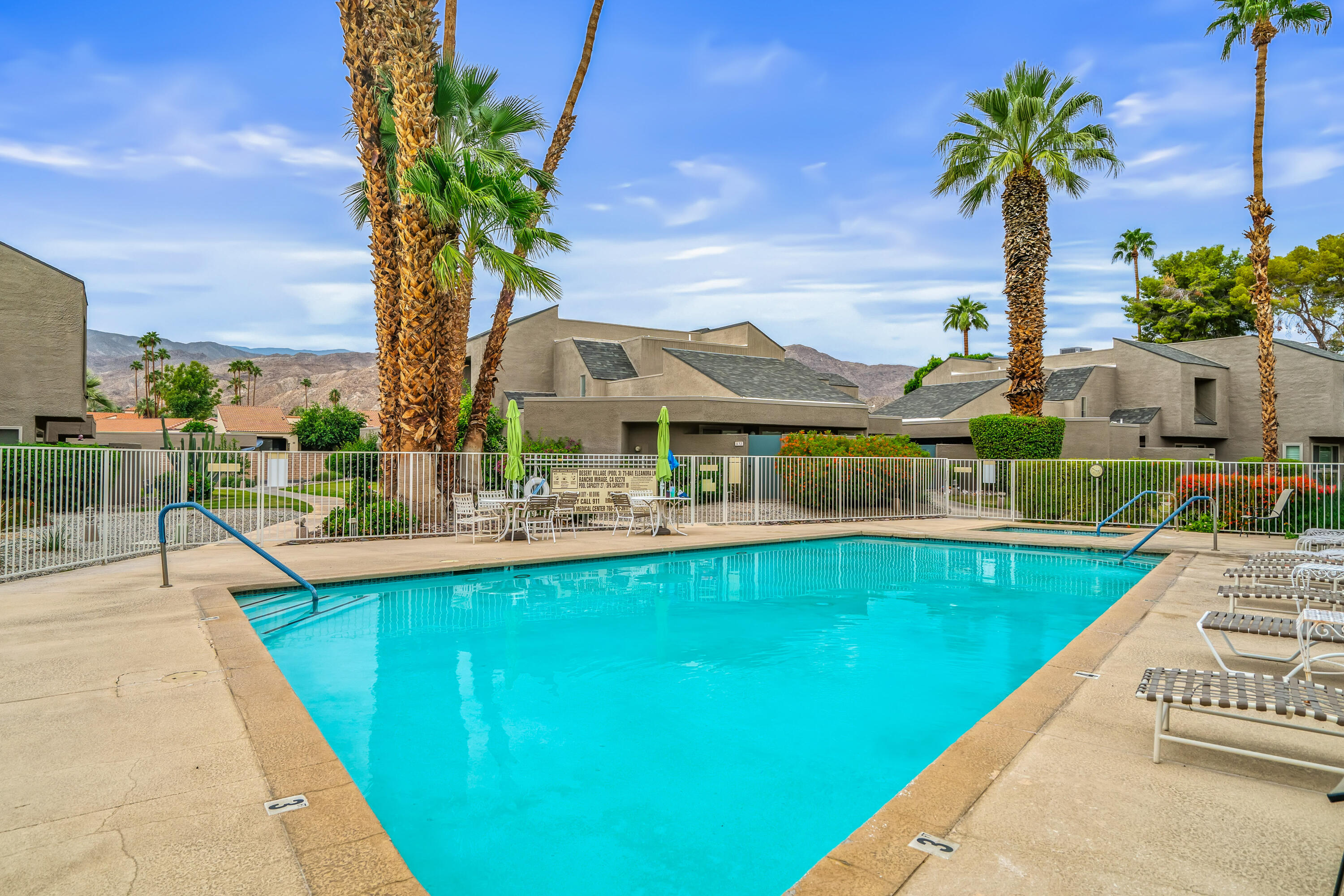 71990 Eleanora Lane Rancho Mirage, CA 92270 - Photo 16 of 22 a view of a swimming pool with a table and chairs
