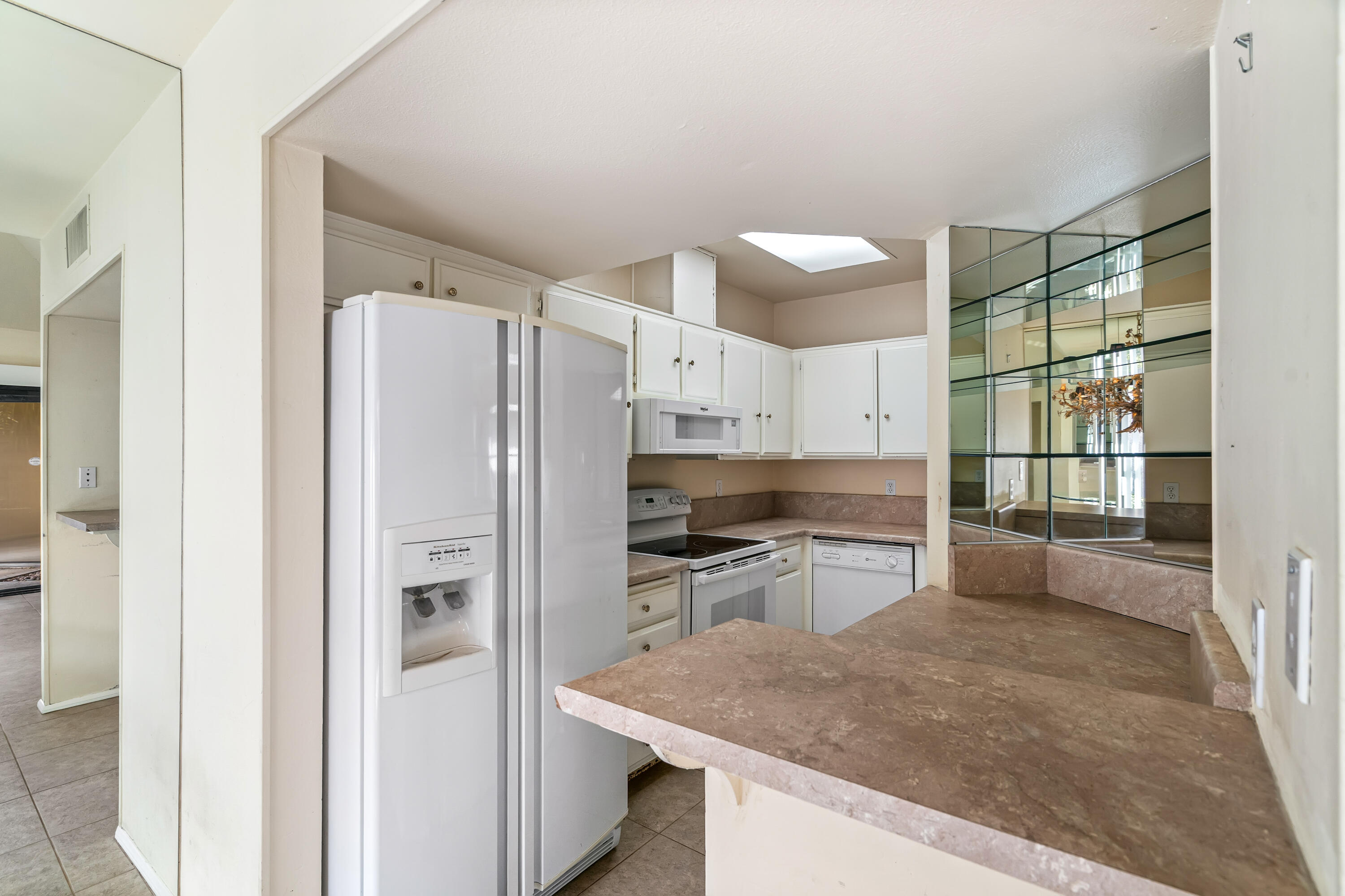 71990 Eleanora Lane Rancho Mirage, CA 92270 - Photo 8 of 22 a kitchen with a refrigerator a sink and cabinets