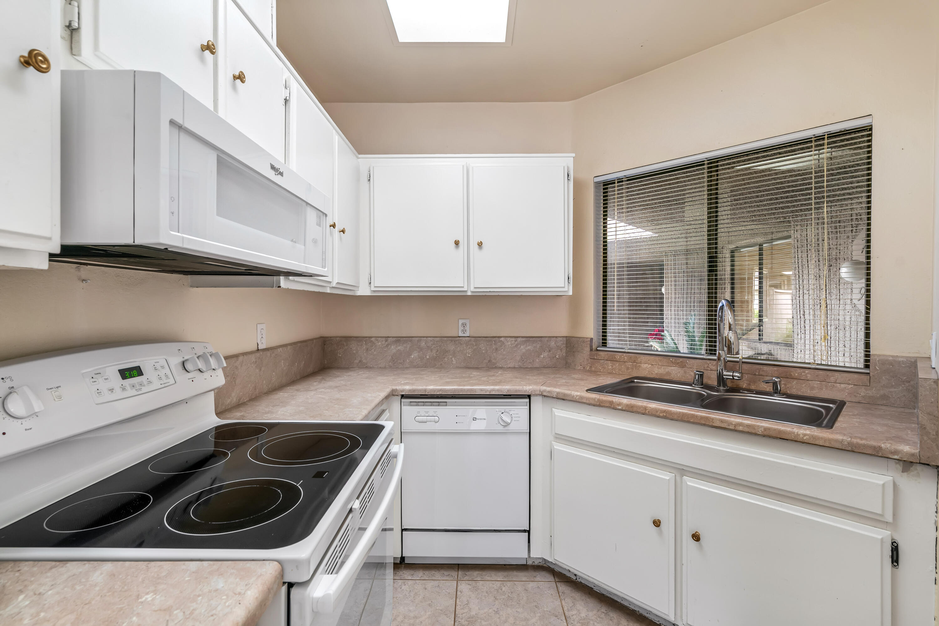 71990 Eleanora Lane Rancho Mirage, CA 92270 - Photo 9 of 22 a kitchen with white cabinets and white appliances