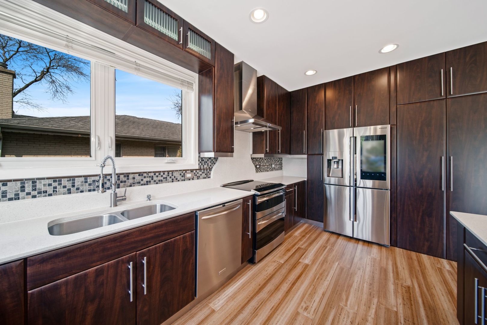 701 Oakton Street Park Ridge, IL 60068 - Photo 15 of 59 a kitchen with kitchen island granite countertop a sink stainless steel appliances and cabinets