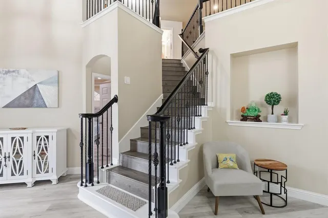 a living room with furniture and a floor to ceiling window