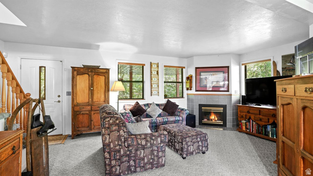 335 Jungfrau Hill Road Midway, UT 84049 - Photo 16 of 34 Living room with a tile fireplace and light colored carpet
