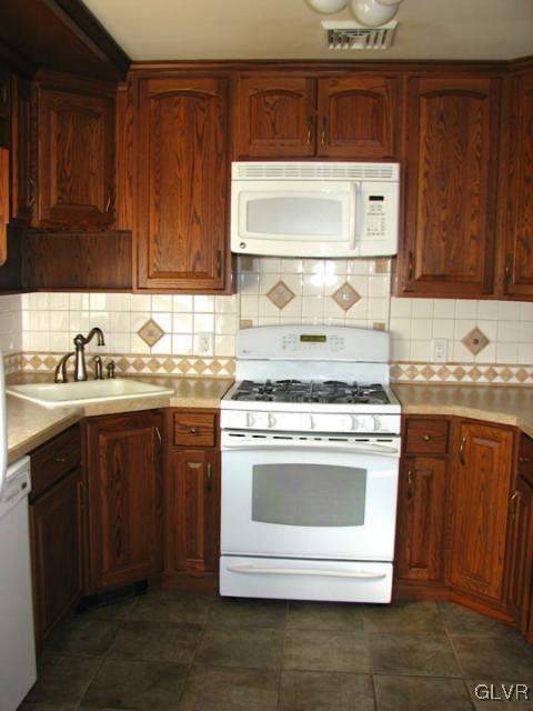 476 Albert Road Wind Gap, PA 18091 - Photo 17 of 45 a kitchen with granite countertop cabinets stainless steel appliances and a sink