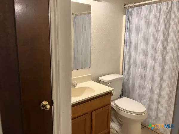 a white toilet sitting next to a bathroom sink
