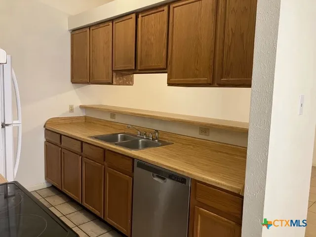a kitchen with a sink and cabinets