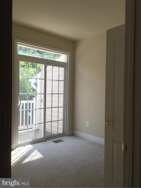 13608 Dover Cliffs Place Germantown, MD 20874 - Photo 16 of 26 a view of empty room with floor to ceiling window