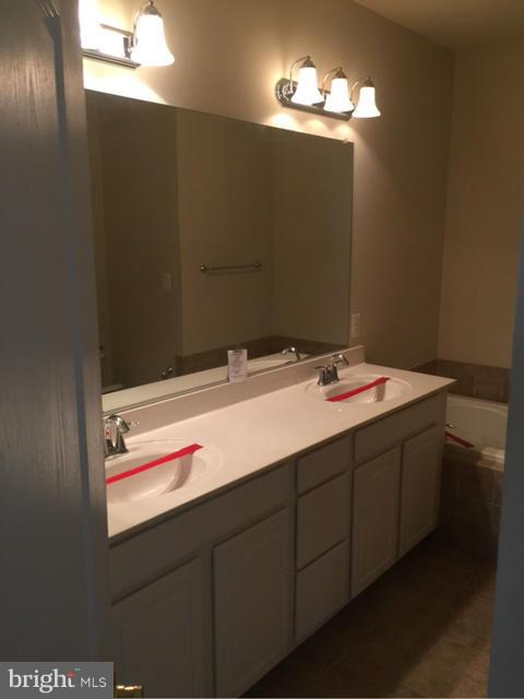 13608 Dover Cliffs Place Germantown, MD 20874 - Photo 17 of 26 a bathroom with a sink and a mirror