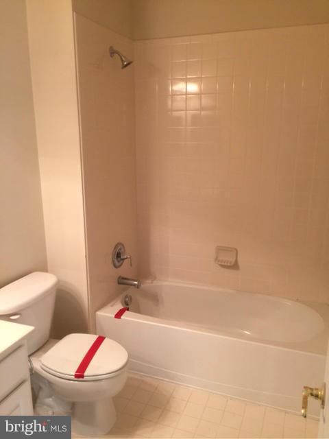 13608 Dover Cliffs Place Germantown, MD 20874 - Photo 24 of 26 a white toilet sitting next to a bath tub and a shower