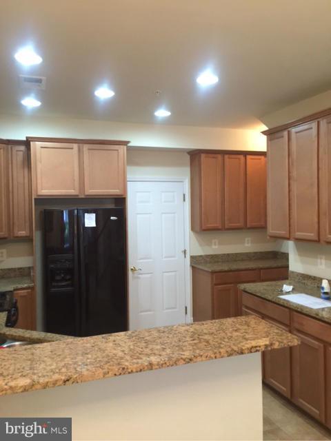13608 Dover Cliffs Place Germantown, MD 20874 - Photo 5 of 26 a kitchen with stainless steel appliances granite countertop a sink stove and refrigerator