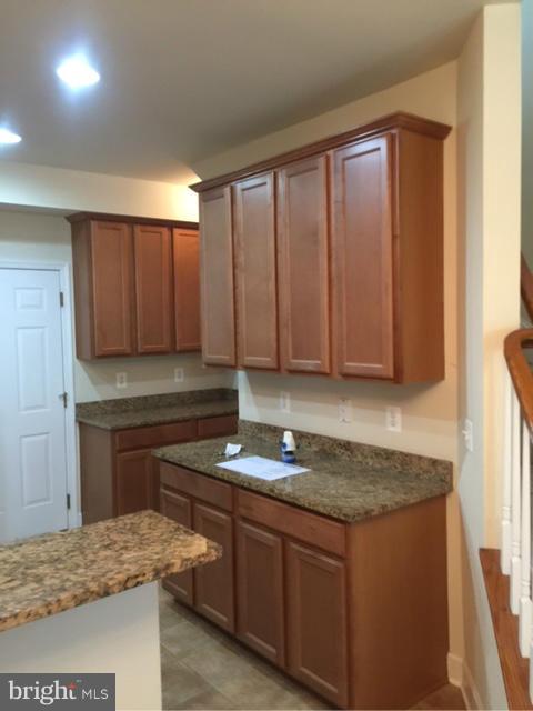 13608 Dover Cliffs Place Germantown, MD 20874 - Photo 7 of 26 a kitchen with granite countertop cabinets and sink