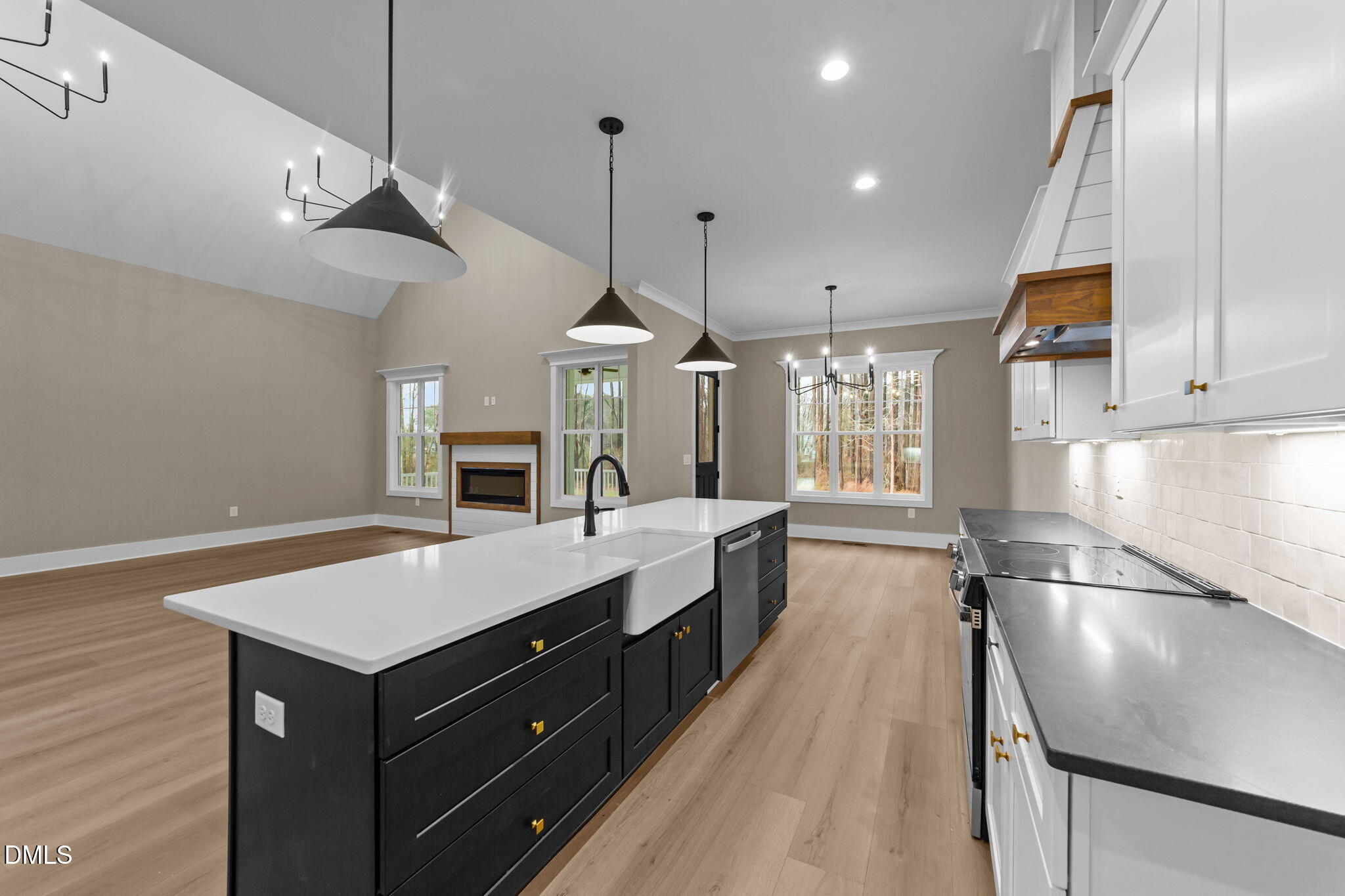2590 Lassiter Road Four Oaks, NC 27524 - Photo 20 of 72 a large kitchen with kitchen island a large island in the center and stainless steel appliances