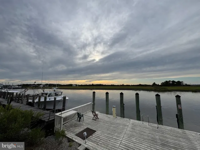 a view of roof deck with two chairs and wooden floor