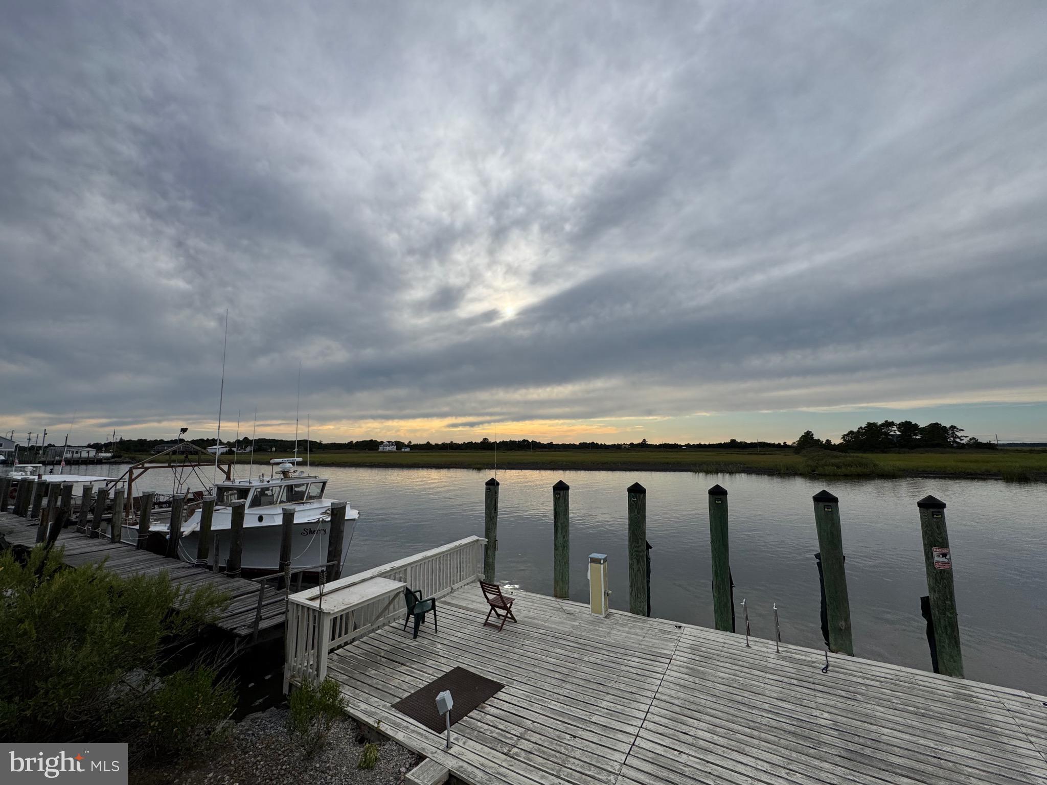 a view of roof deck with two chairs and wooden floor