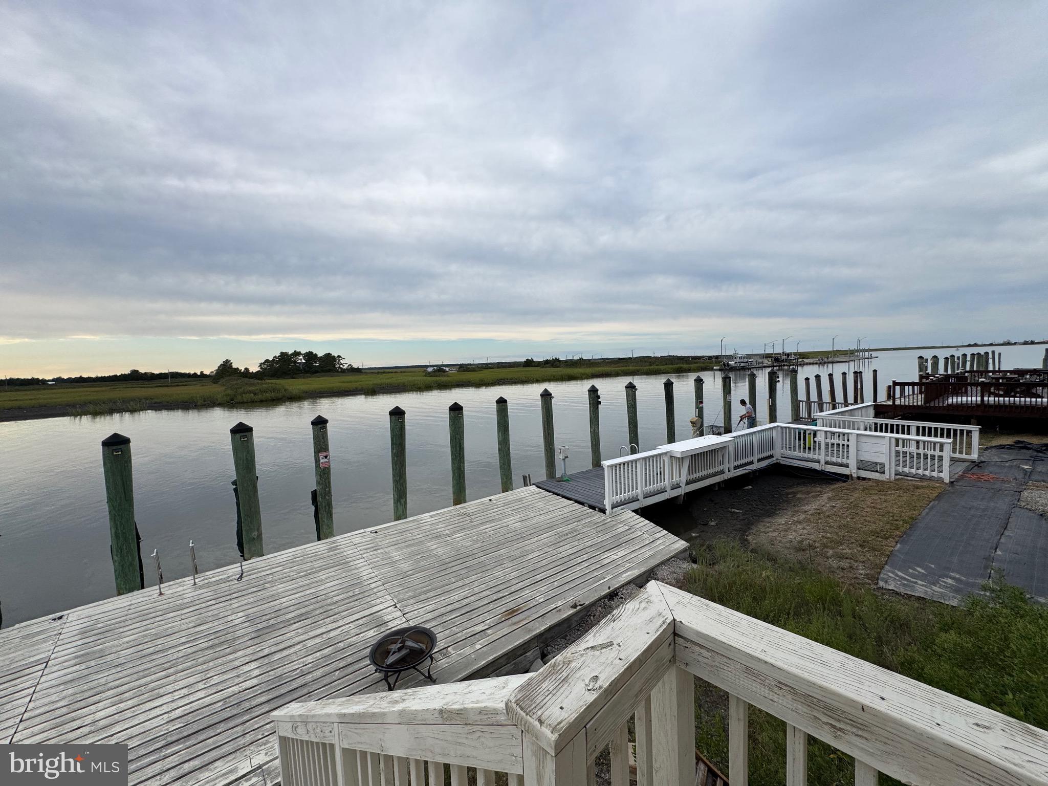 128 Sawyer Road Milford, DE 19963 - Photo 11 of 47 a view of roof deck with two chairs and wooden floor