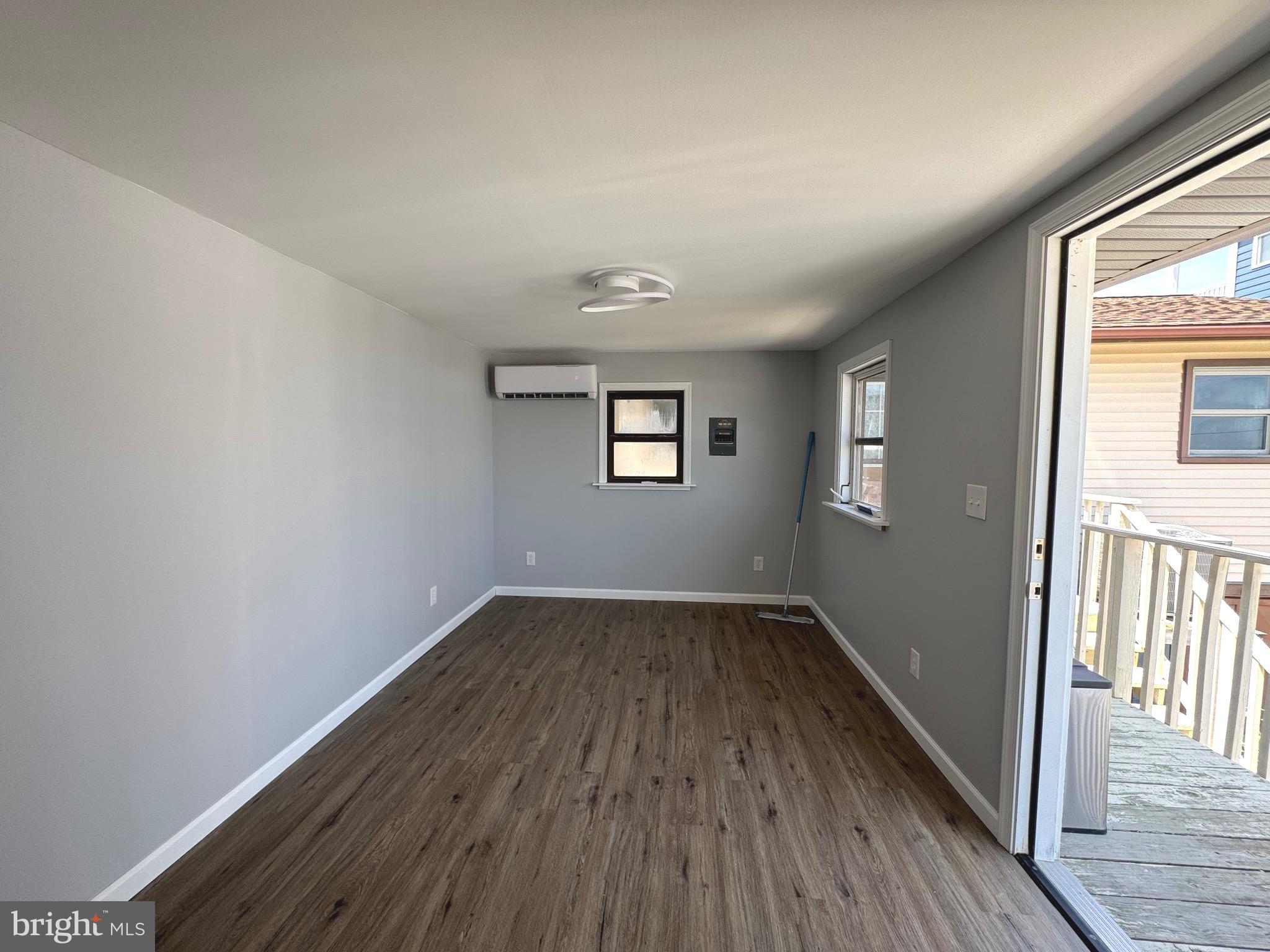 128 Sawyer Road Milford, DE 19963 - Photo 13 of 47 an empty room with wooden floor and windows
