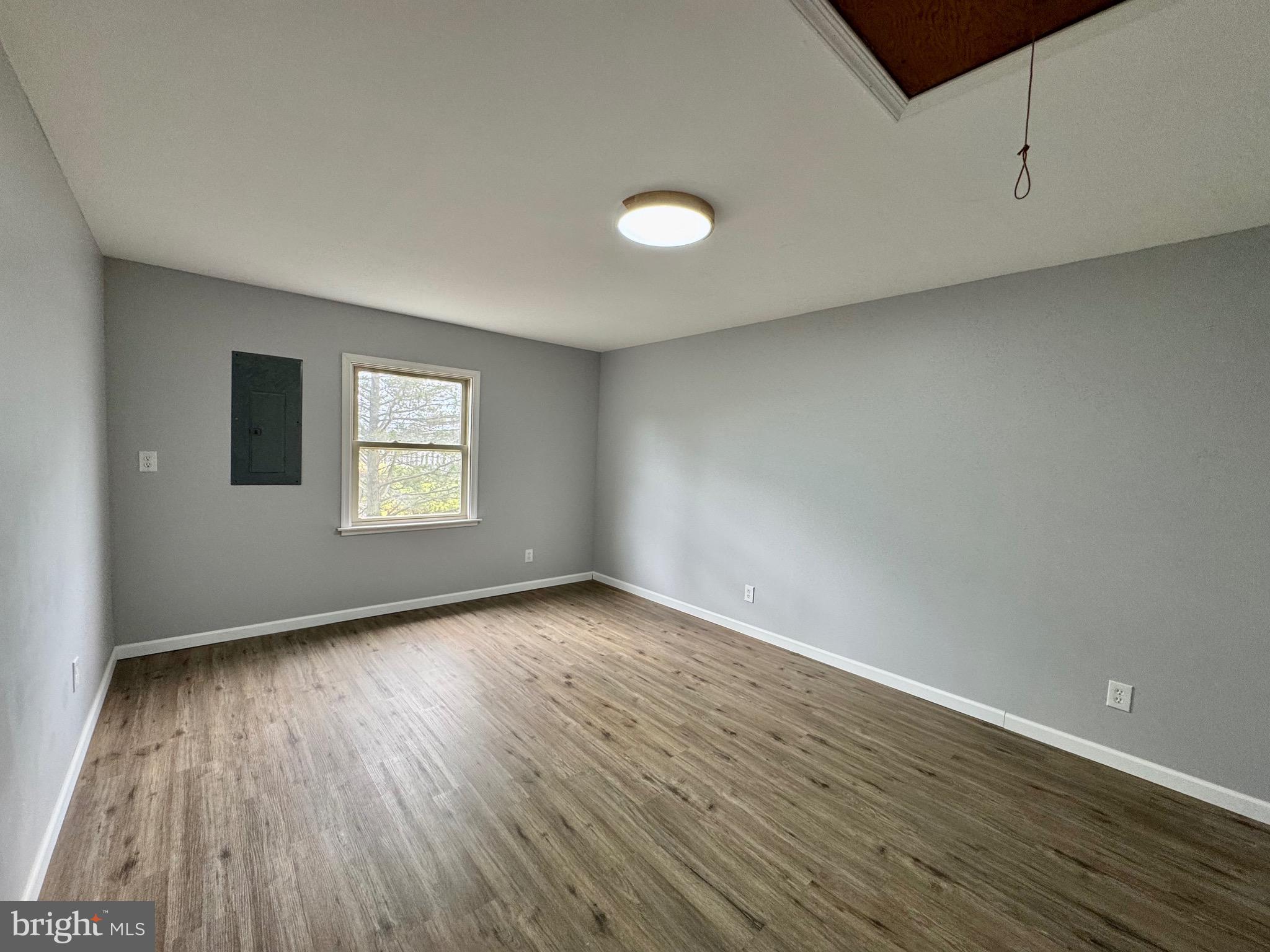 128 Sawyer Road Milford, DE 19963 - Photo 16 of 47 an empty room with wooden floor and windows